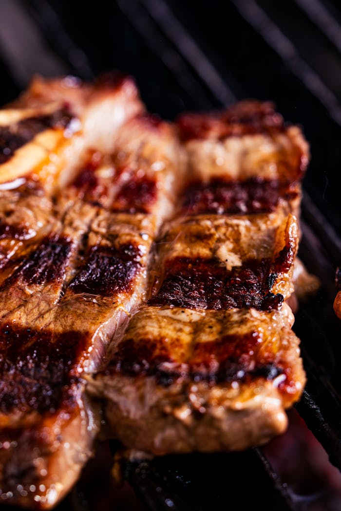 Close-up of a sizzling grilled steak showcasing delicious char marks.